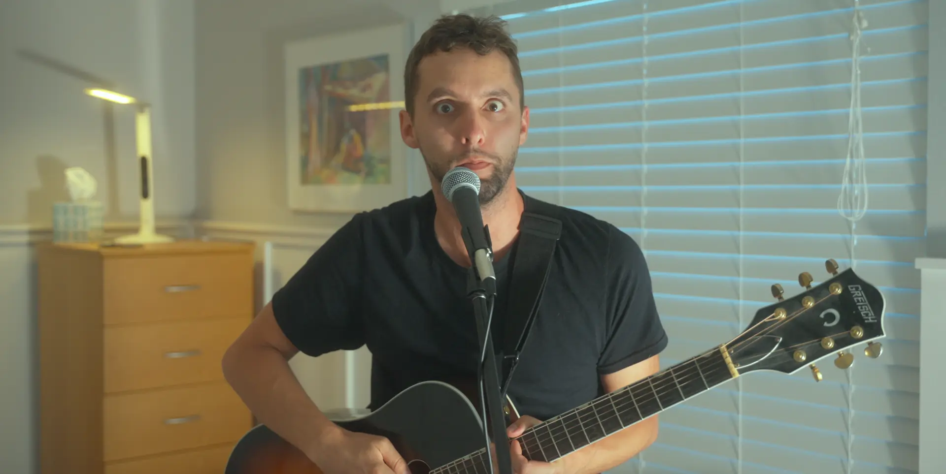 Ben performing with guitar and microphone